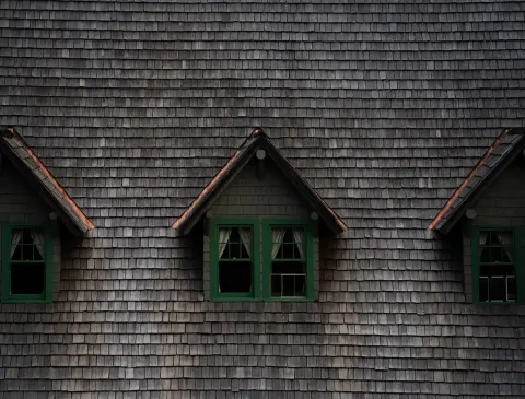 Close-up of a historic building with three charming dormer windows in Washington, USA.